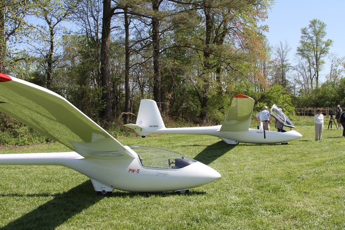 A glider in flight over open country.